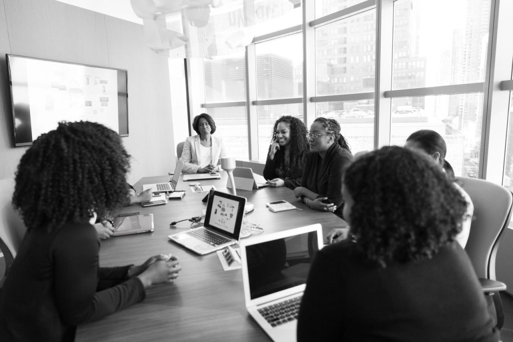 Mastering the First Impression: Your intriguing post title goes here Black women collaborating in a modern office meeting. Engaging and productive work environment.